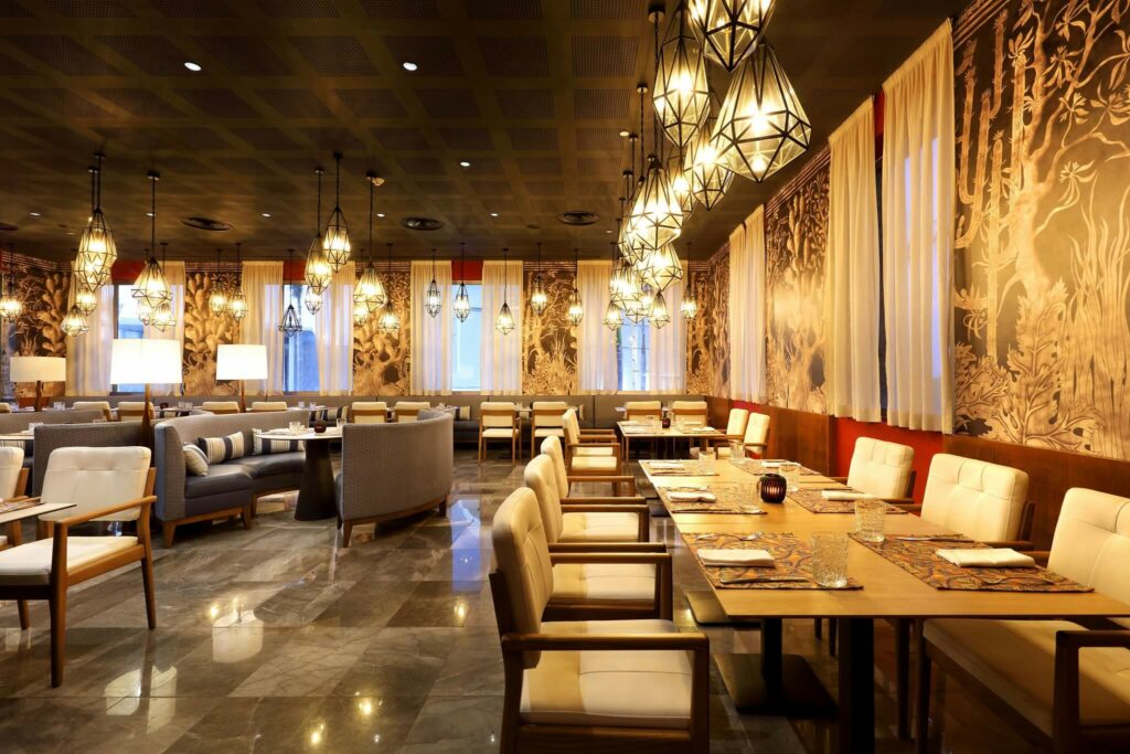 elegant restaurant with marble floors, wallpaper and hanging lanterns