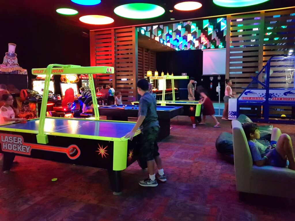 kids playing at the arcade room of a beach resort in cancun