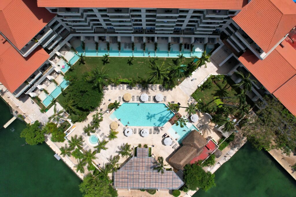aerial view of a beach resort in the riviera maya, with pools, bars and swim up suites