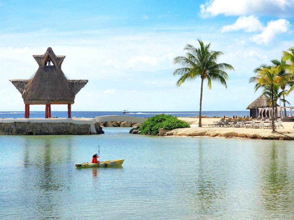 Hotel guest kayaking in the beach of a resort in mexico