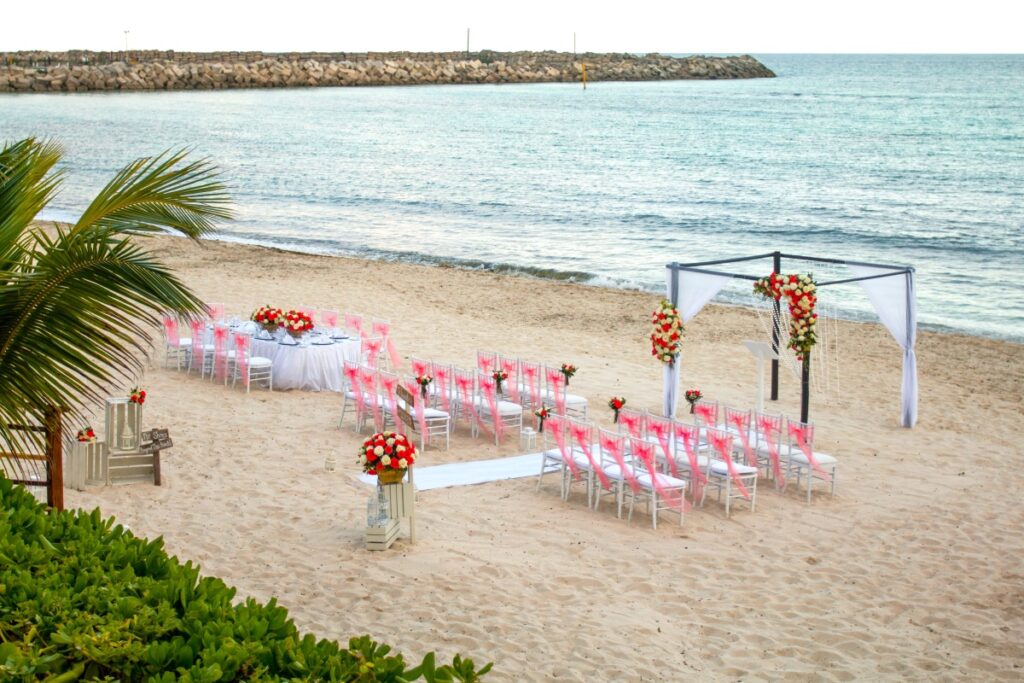 a small wedding ceremony set up on the beach of a resort in riviera maya
