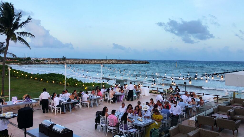 a wedding reception set up on a terrace by the beach