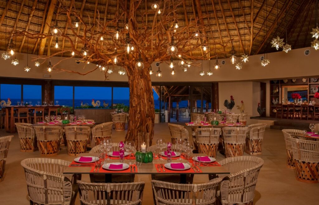 Mexican restaurant with palapa roof, ocean view, hanging lanterns and a beautiful tree structire with lights