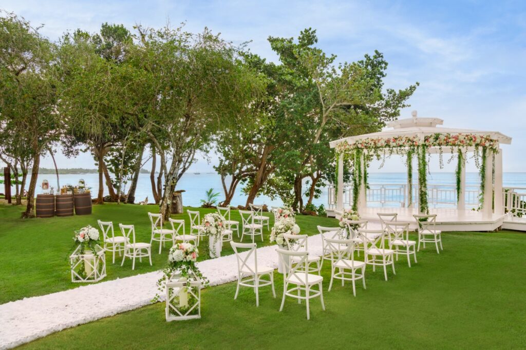 Oceanfront wedding gazebo with lots of trees and green grass