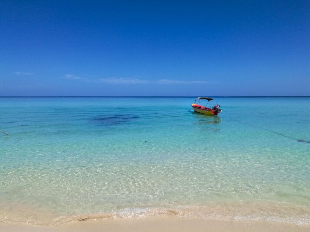 A fishing boat on a super clear beach in Montego Bay, Jamaica