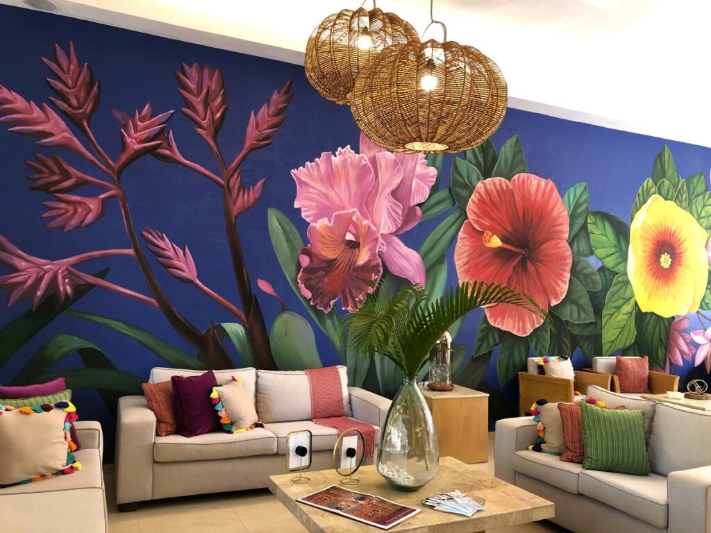 A colorful lobby mural at a beach wedding resort in cancun with tropical flowers and greenery