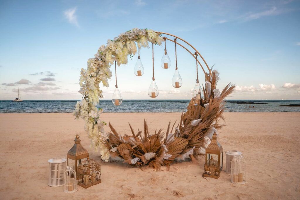 el dorado maroma wedding ceremony arch at the beach with white flowers and dry greenery