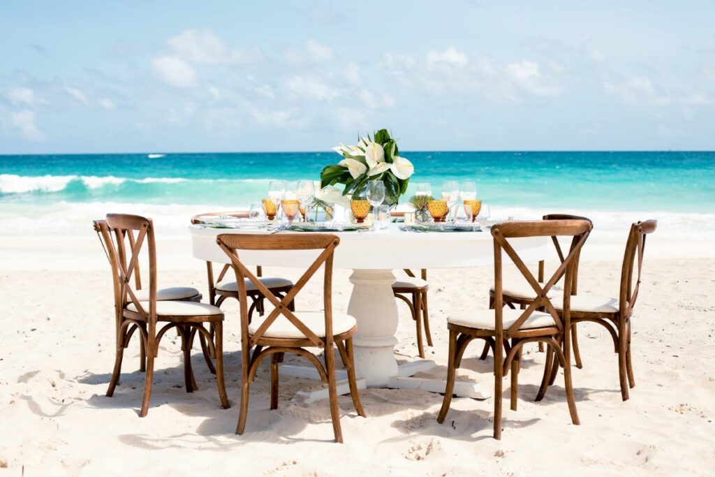 Table set on the beach for a wedding reception with gannets center piece