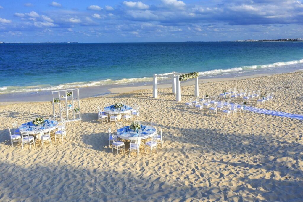 beautiful beach wedding set up all in white and blue at the planet Hollywood cancun weddings resort
