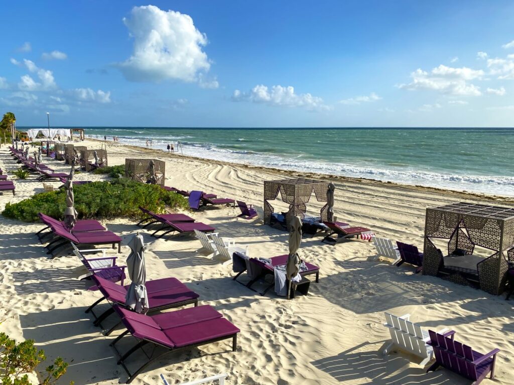 beach area with cabanas and lounge chairs at planet hollywood cancun