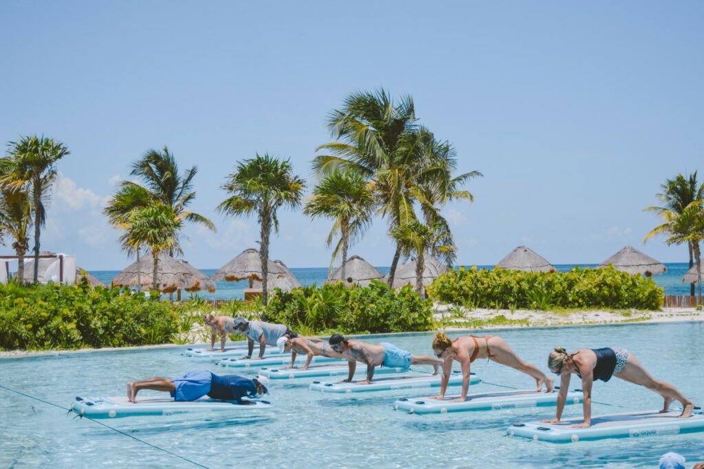 paddle yoga at the pool of secrets maroma beach weddings resort
