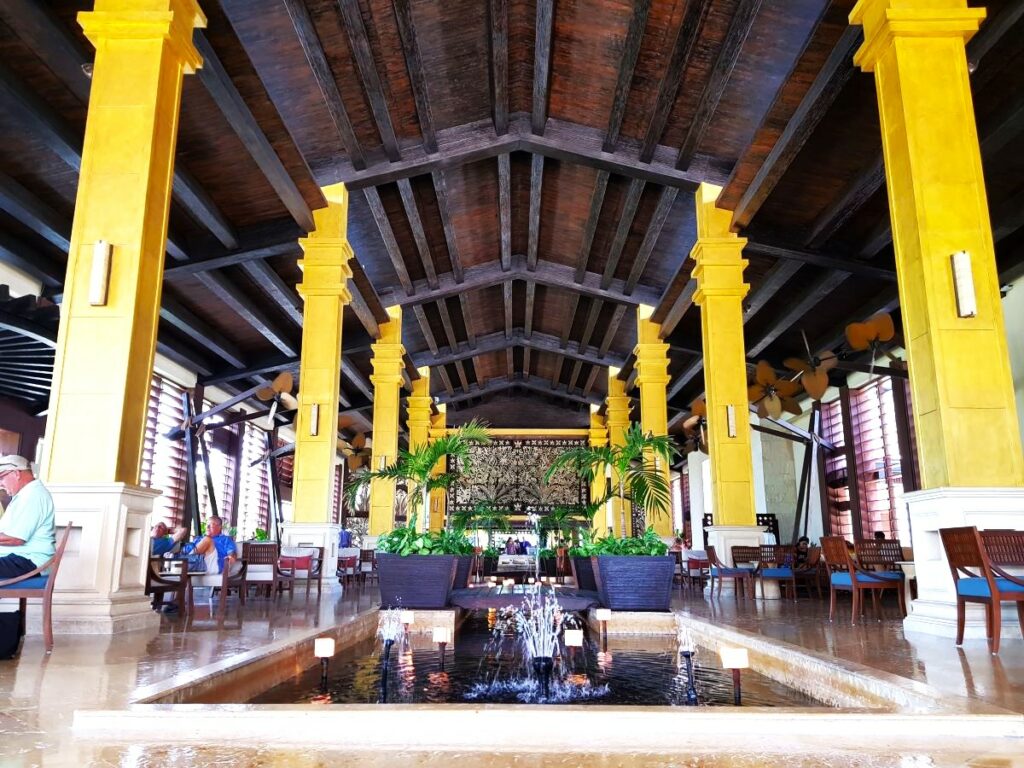 Fancy hotel lobby with wooden roof and reflecting pool