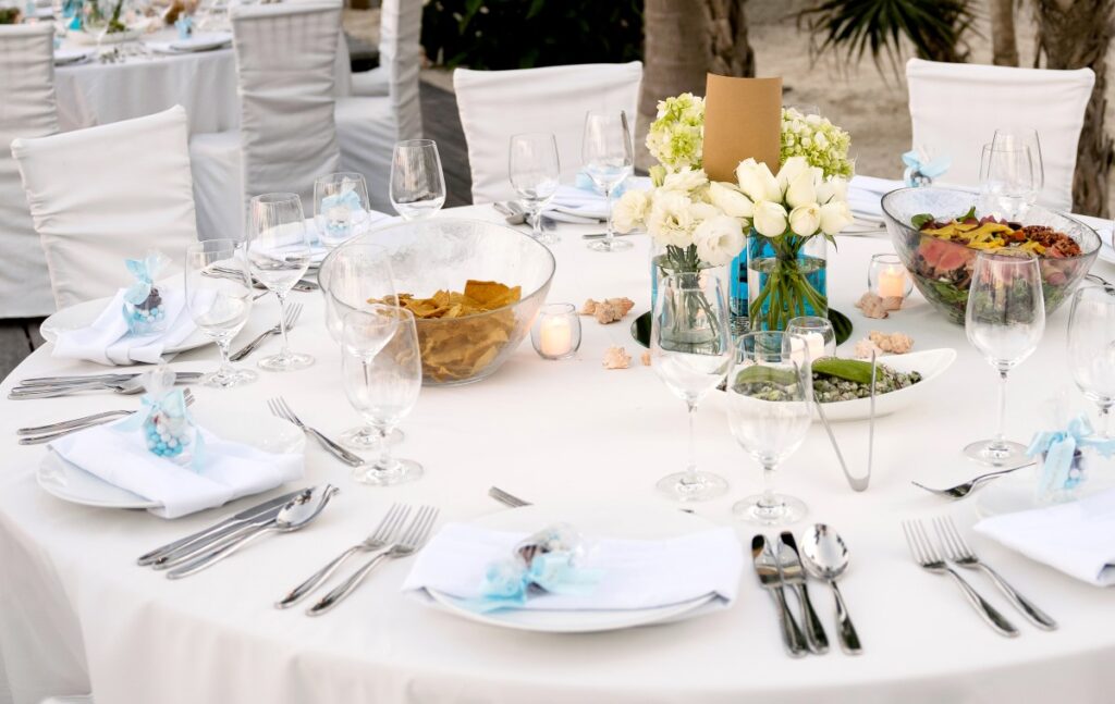 wedding table set up in white with tropical flowers