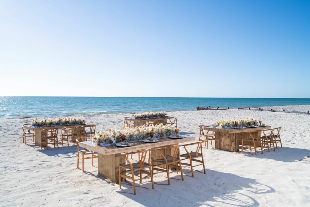 Beachfront area with long tables and chairs