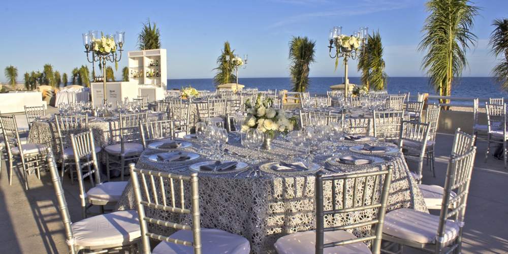 elegant wedding set up on a terrace with ocean views