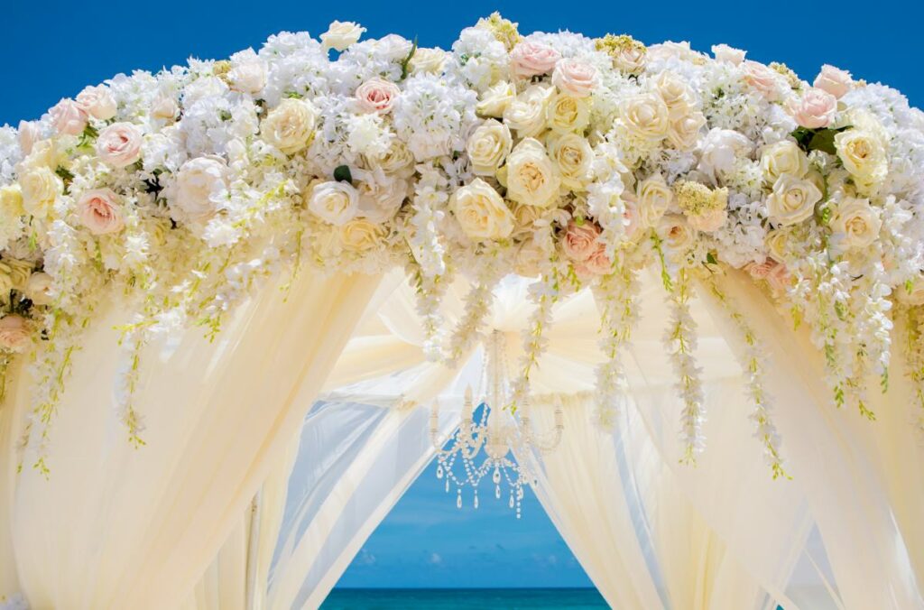 wedding pergola with white drapes and beautiful flowers