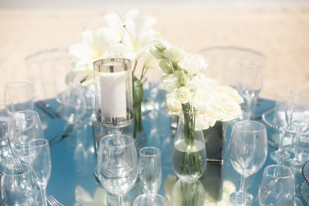 modern wedding reception set up with mirrors and white flowers