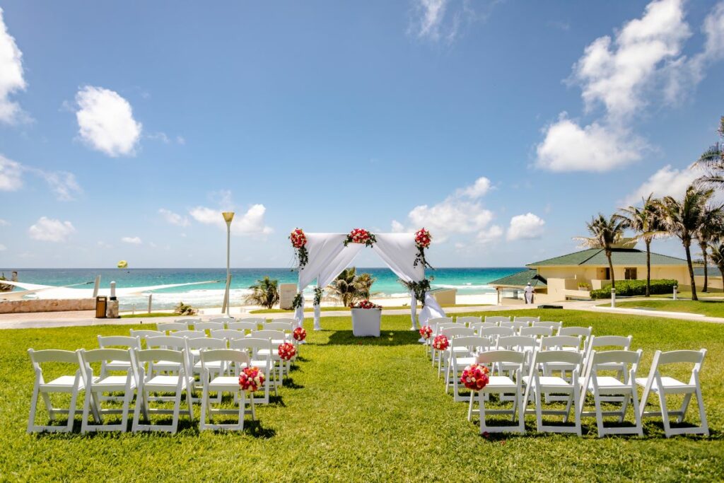 wedding ceremony set up in a garden with ocean view