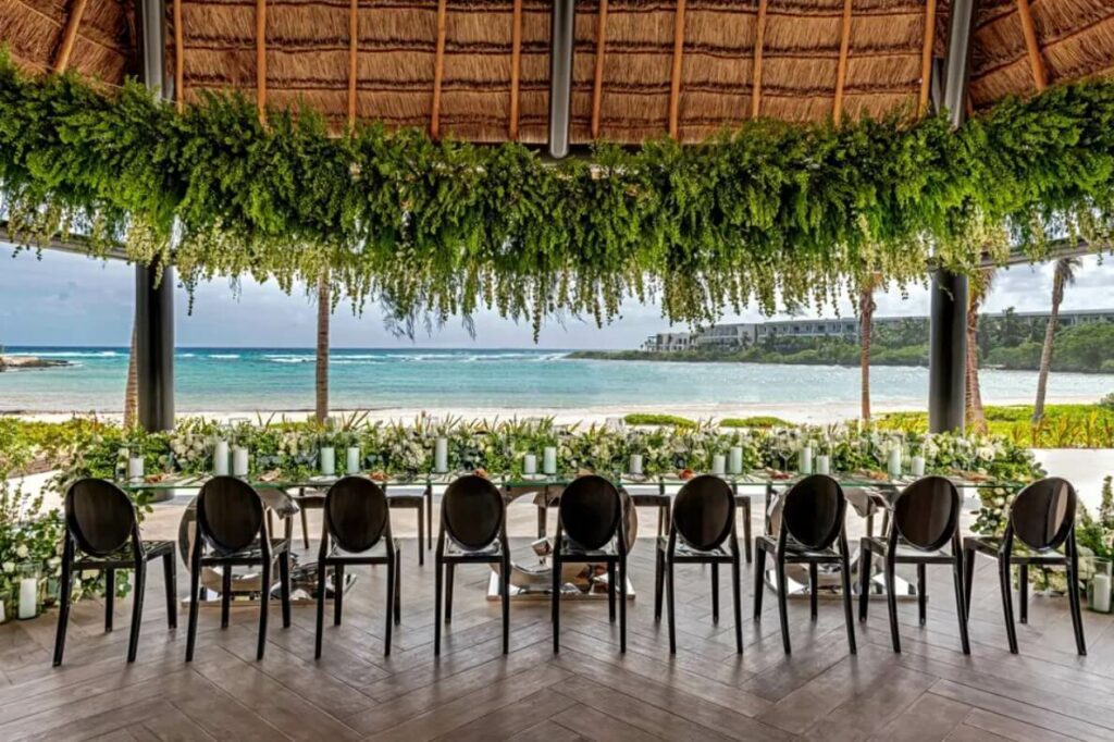 wedding reception set up at an ocean front palapa in tulum